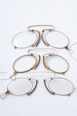 a set of five pairs of glasses on a white surface