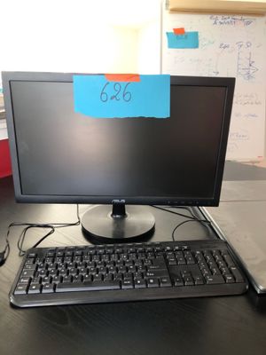 an image of a computer monitor and keyboard on a desk