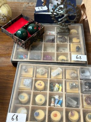 two trays of candles and a box of candles on a table