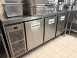 stainless steel counter top in a commercial kitchen with pots and pans on it