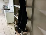 a coat hanging on a shelf in a kitchen