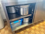a stainless steel cabinet with pots and pans on it