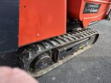 a close up of a red tractor with a black tire