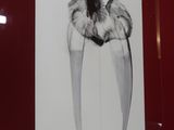 a black and white picture of a tooth on a red wall