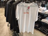 a t - shirt hanging on a rack in a clothing store