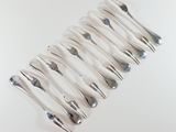 a close up of a silver object on a white surface