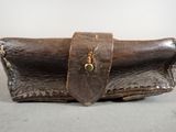 a brown leather case with a metal clasp on it