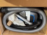 a box with a vacuum and a hose inside of it