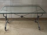 a glass table with a metal frame and a glass top