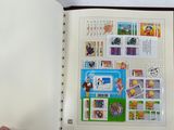 a person holding a book with stamps on it