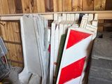 a pile of construction equipment in a room with wood paneled walls