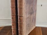 two books that are sitting on a wooden table