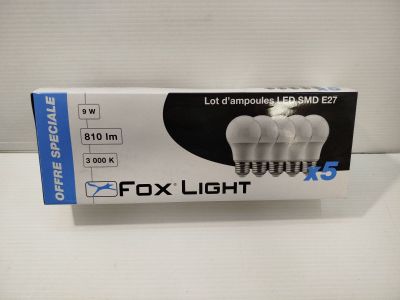 a box of four white light bulbs sitting on top of a table