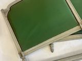 two green trays sitting on top of a white sheet