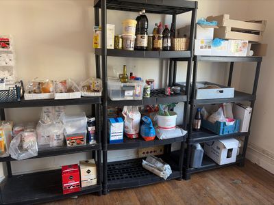 many shelves with various items on them in a room