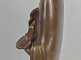 bronze statue of a man holding a hat and a glove