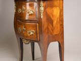 a small chest of drawers with a marble top