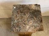 a piece of wood sitting on the floor next to a wall