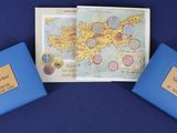 three blue boxes with maps on them on a blue surface