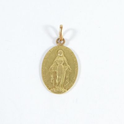 an image of a gold coin with the image of the virgin mary on it