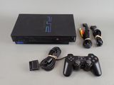 a video game console with a game controller next to it