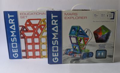 boxes of educational toys for kids on a white surface