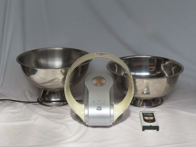 a silver bowl and a silver bowl on a table