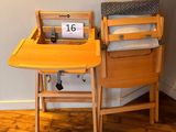 a small table with a chair and a laptop on it