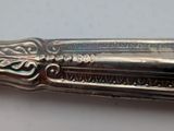 a close up of a silver spoon on a table