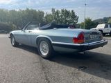 an image of a blue convertible car parked in a parking lot