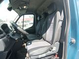 a seat in the back of a truck with a suitcase in it