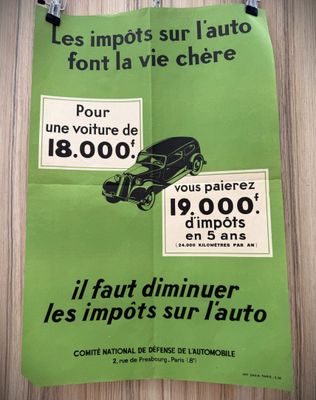 french poster of a green car and a black car on a wooden wall