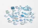 some very pretty blue and white gems on a white surface