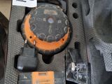 an orange and black object in a case on a table