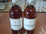 deux bouteilles de vin posées sur une table, avec une étiquette de prix