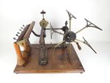 an old machine that is sitting on a wooden stand