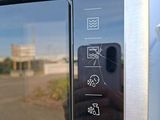 a person taking a picture of a microwave with their phone