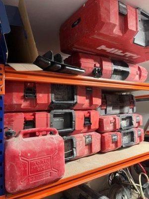 many different tools on the shelves in the garage