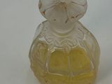 a small glass bottle with a yellow base and a white top