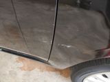 a close up of a car ' s front bumper and tire