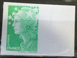 a green stamp with a woman ' s face on it