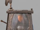 a statue of a bird sitting on top of a box