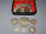 a red box filled with silver coins on a table