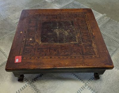 a wooden table with a decorative design on it