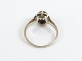 a close up of a silver ring with a black stone in the center