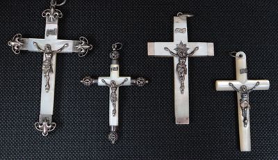 three silver crosses with a cross on each of them and a cross on the other