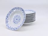 several blue and white plates stacked on top of each other