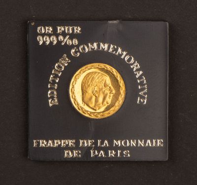 a close up of a gold coin on a black surface