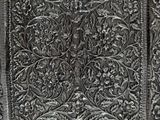 close up of a metal door with intricate designs on it
