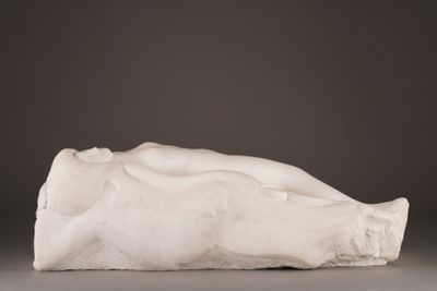 an image of a sculpture of a woman laying down on the ground